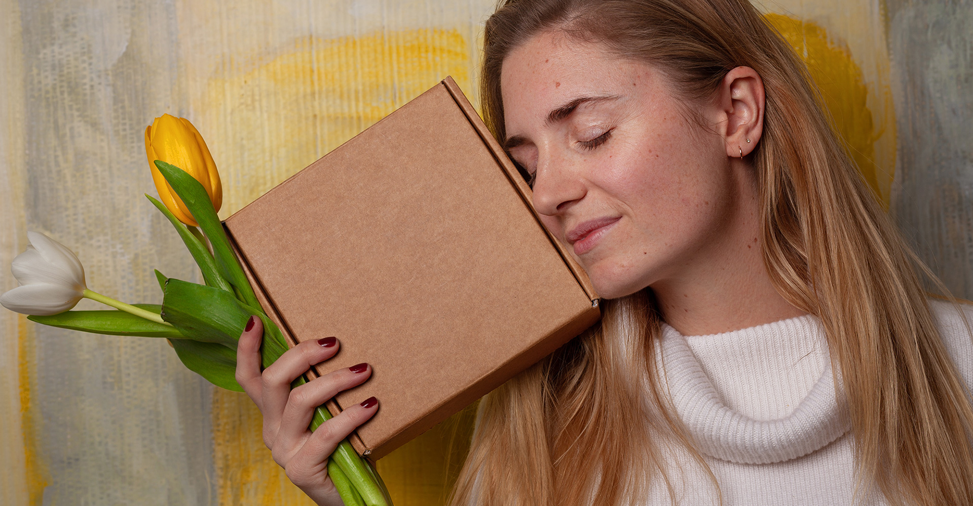a woman with a package looking very happy