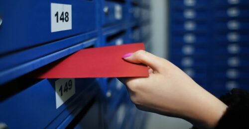 envelope being put into mailbox