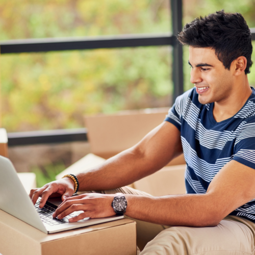 man updating address on laptop