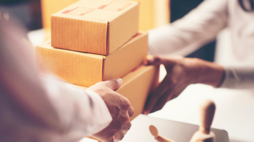 handing over stack of boxes