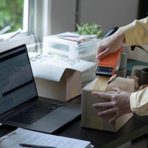 person preparing box for shipping
