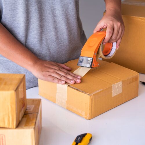 Person taping shut a package