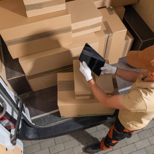 Mail man unloading boxes