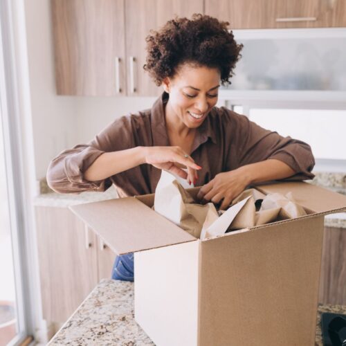 a woman packing a box to ship