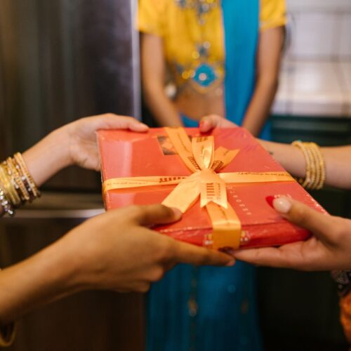 a person handing over a gift