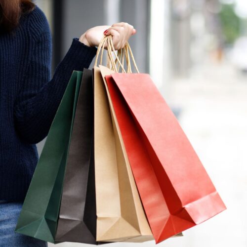 a shopper holding multiple bags