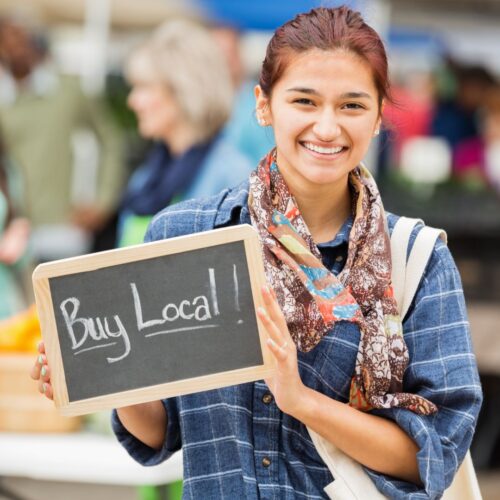 woman with buy local sign