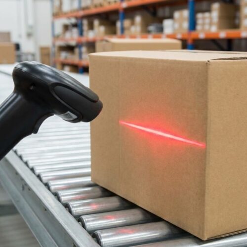  Close-up of a barcode scanner being used on a shipping box label.
