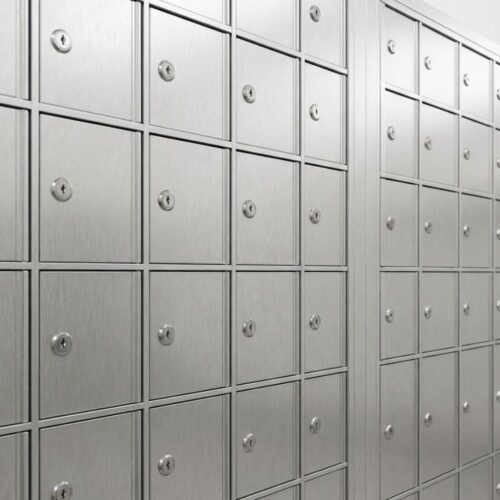 Modern row of secure silver metal mailboxes in a clean facility.
